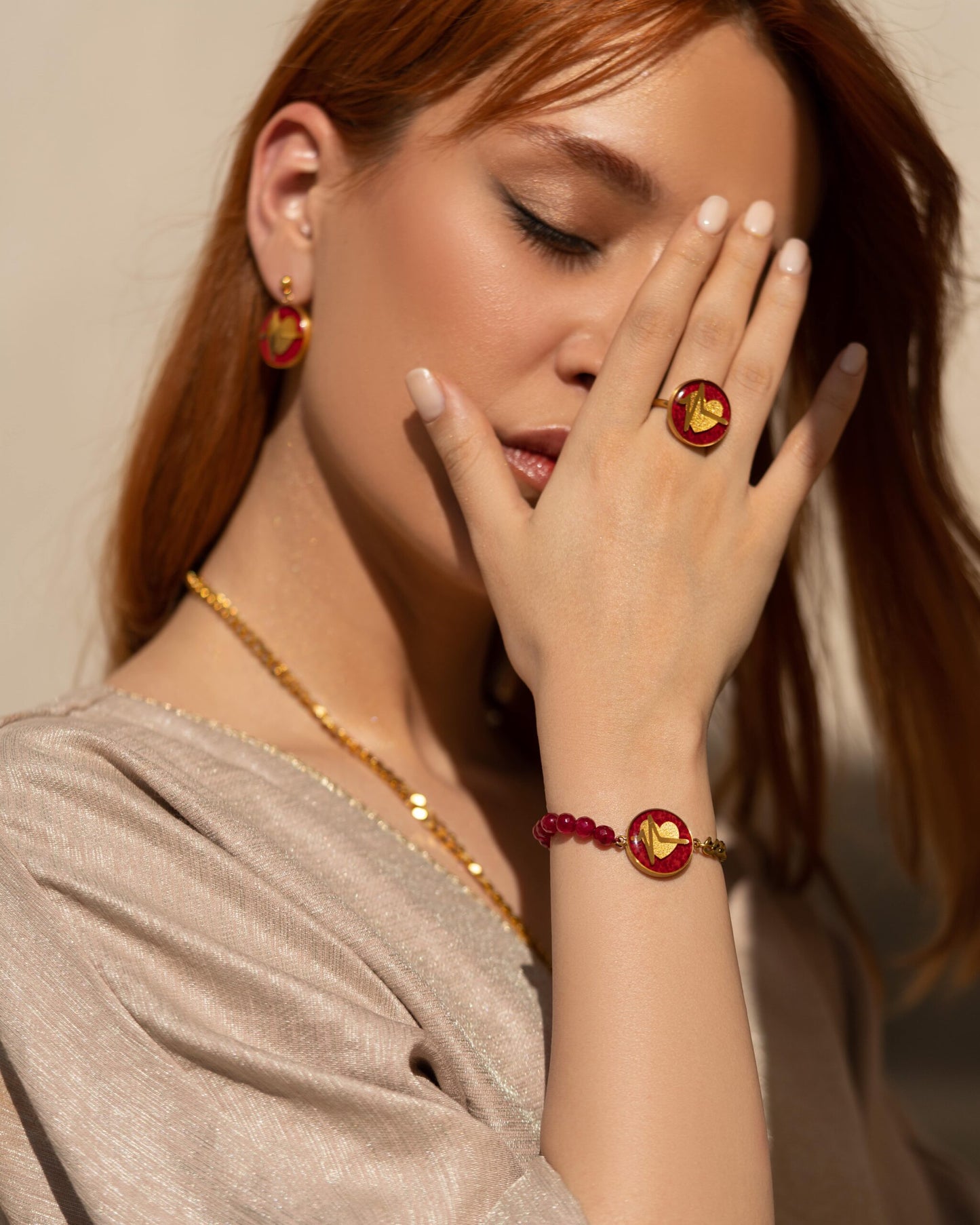 Bracelet, heart design made of 24 carat gold leaf, red jade, stainless steel